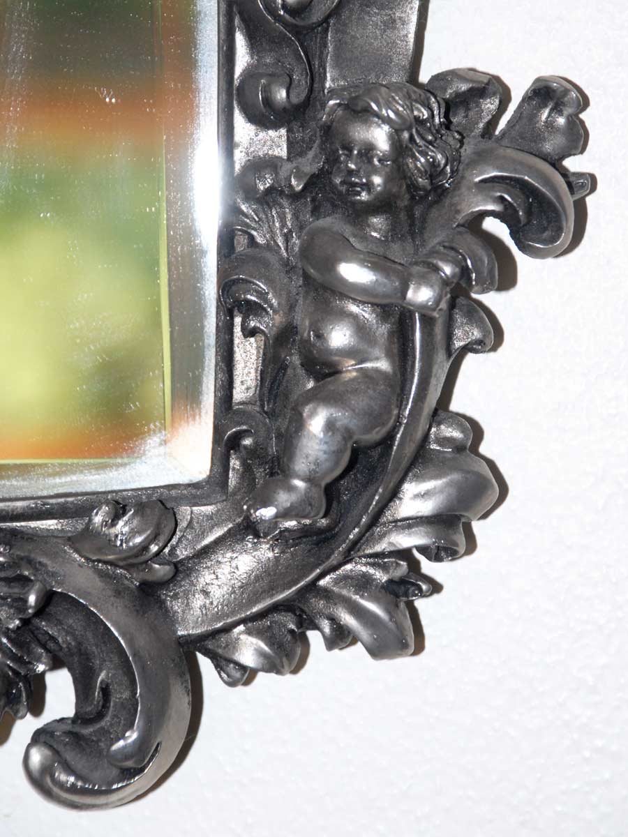 metal mirror with cherubs