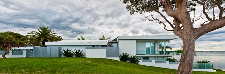 House in Coastal Oasis landscape project by Urban Exotic