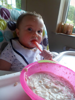 Baby eating homemade banana porridge.