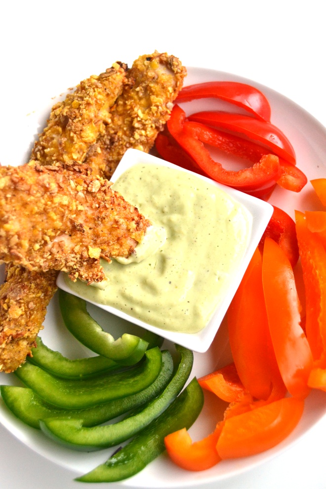Baked Chicken Tenders with Avocado Jalapeno Dipping Sauce are a lighter take on typical chicken strips with a crunchy cereal breading that everyone will love! www.nutritionistreviews.com