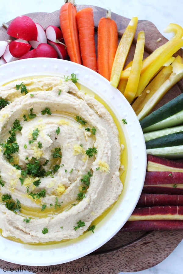 This is the best homemade garlic hummus recipe! It's super easy to make in your Instant Pot. The lemon and garlic flavors are perfect. This vegan recipe is also gluten free and perfect to serve with veggies.  #creativegreenliving #creativegreenkitchen #hummus #instantpot #instantpothummus #garlichummus #vegan #vegansnacks #glutenfree #freefrombad #wildharvest