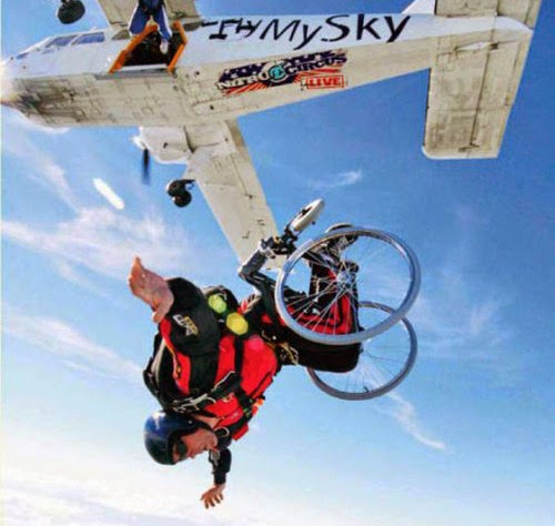 person in a wheelchair having just jumped out of an airborne airplane