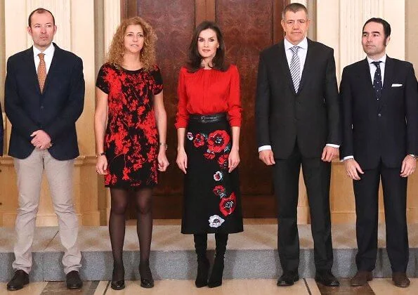 Queen Letizia wore Hugo Boss Banora red gathered neck silk blouse and Carolina Herrera black poppy-print knit skirt, gold diamond earrings