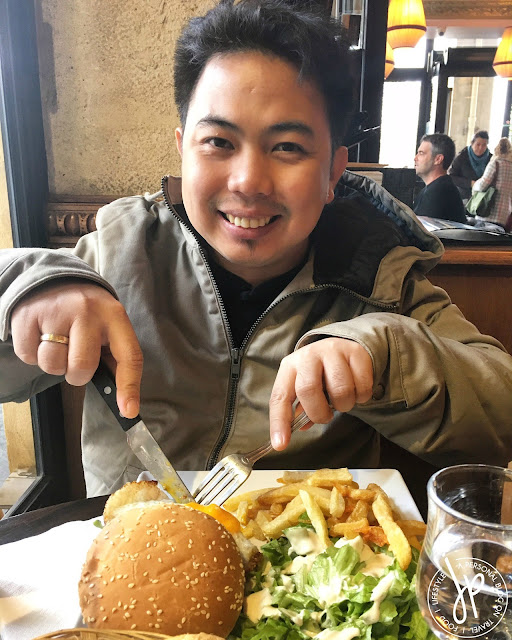 man eating burger at restaurant