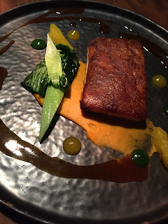 Confit suckling piglet, sweet potato purée, pak choi, orange jus