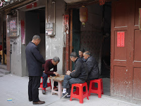 men playing and watching a game of xiangqi on Zhi Street (直街) in Xiapu County, Ningde, Fujian Province, China