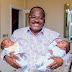 Oyo State Governor Abiola Ajimobi cradles his new twin grandchildren