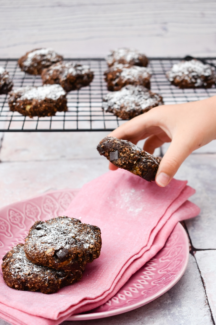 Oaty Chocolate and Banana Cookies, with child's hand snatching one