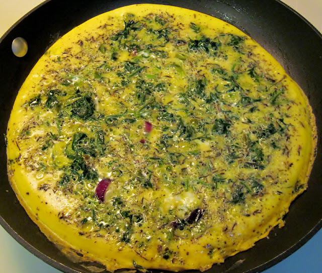 Cooking frittata with carrot leaves