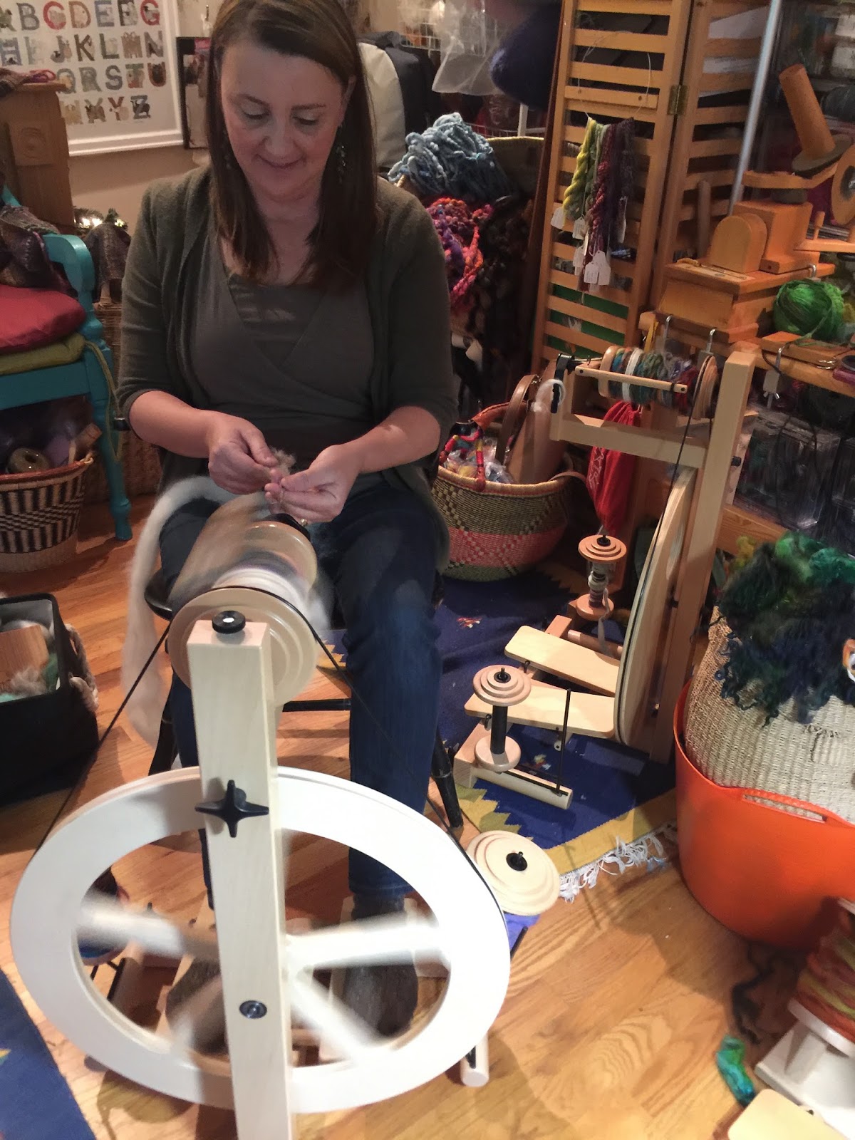 Spinners and weaver working on spinning wheels making yarn at the