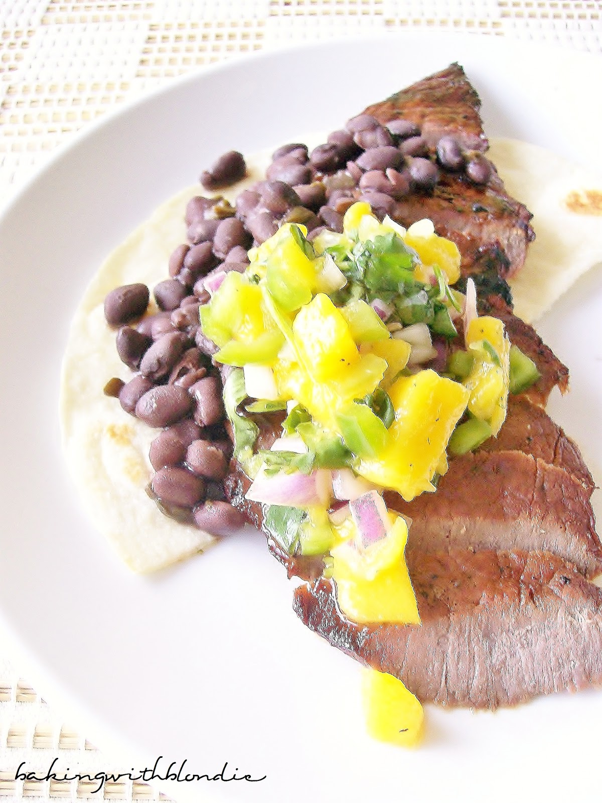 Skirt Steak Tostadas with Spicy Black Beans and Fresh Mango Salsa
