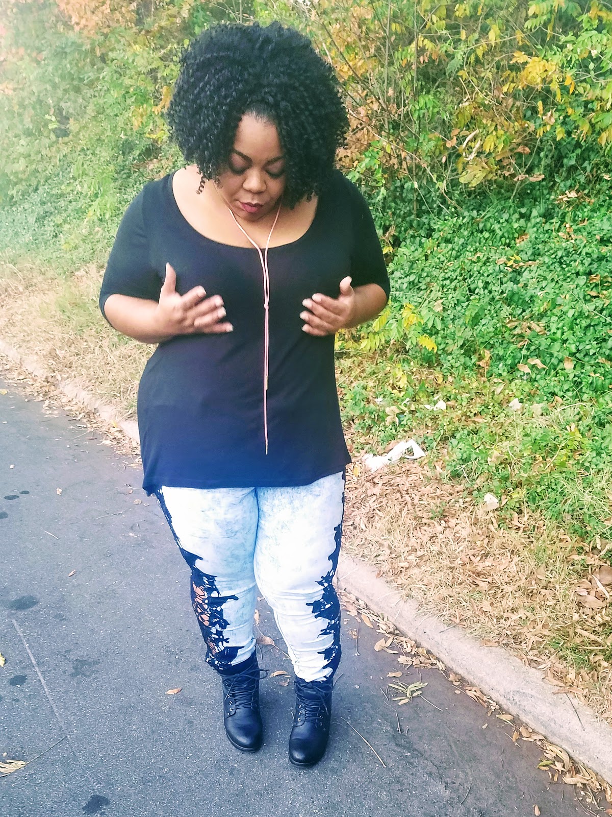 Plus size blogger with thick thighs and round hips in statement jeans and stacked booties