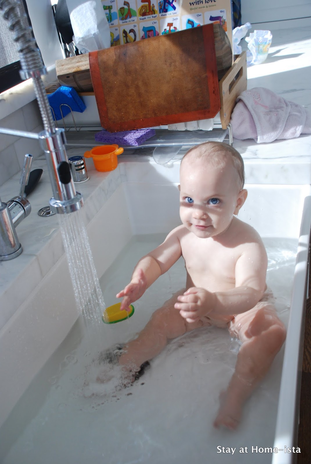 baby naked bath High angle view of cute naked baby boy looking away while ...