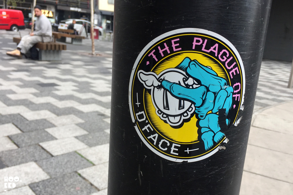 London artist D*Face - Shoreditch Street Art Stickers on Bacon Street