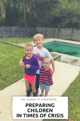 Text: The Journey of Parenthood Preparing Children in Times of Crisis  Picture: 3 children, one boy and two girls, standing with arms around each other in front of pool in a backyard