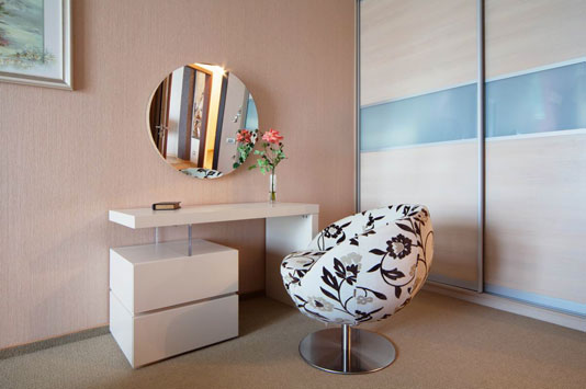 modern small white dressing table with upholstered chair round mirror