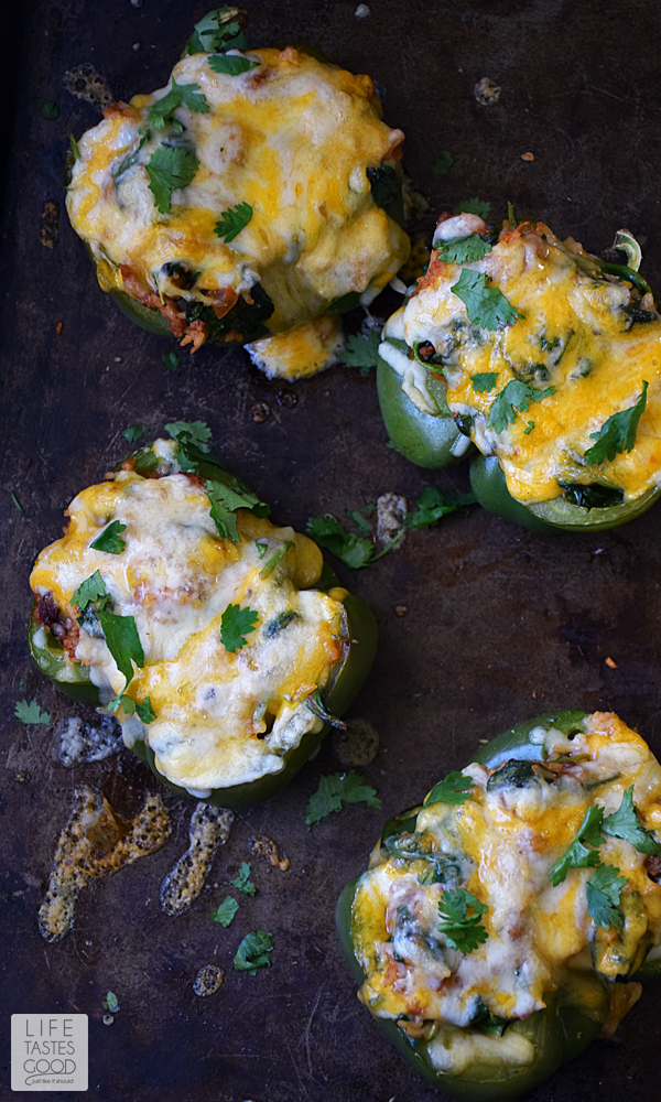 Green Peppers | by Life Tastes Good are stuffed with a mixture of turkey sausage, spinach, fresh herbs & Basmati rice in a spicy salsa topped off with ooey gooey cheese are easy to make and packed full of exciting flavors. #LTGrecipes