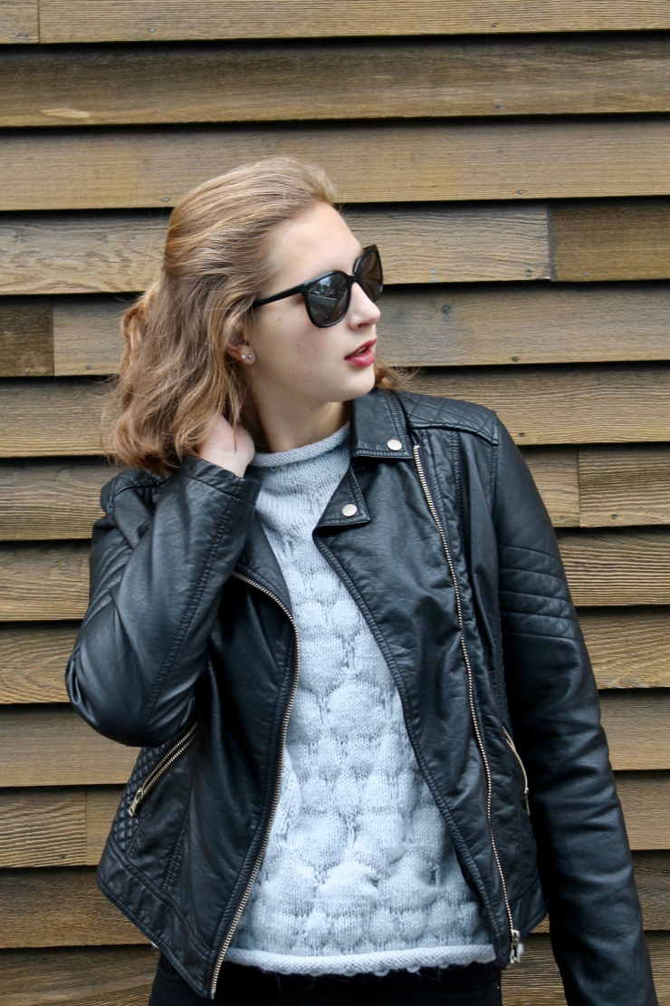 leather jacket, hand knit sweater, black skinny jeans and white trainers