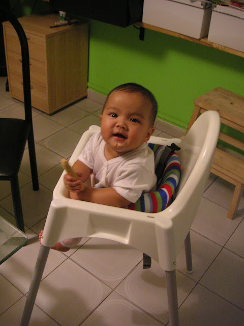 Kecil in baby chair at home