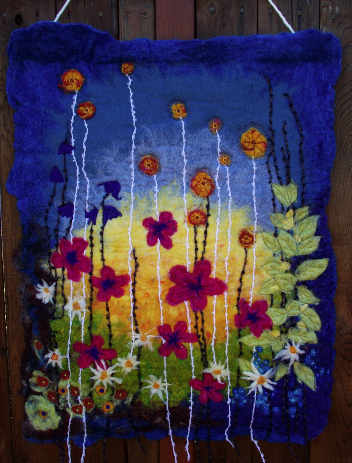 passengers on a little spaceship felted wool wall hanging