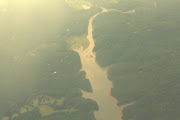 A river from the plane flight after a storm. You can see the mud washing . (img )