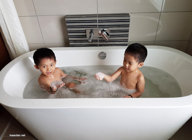The boys, soaking in the bath tub