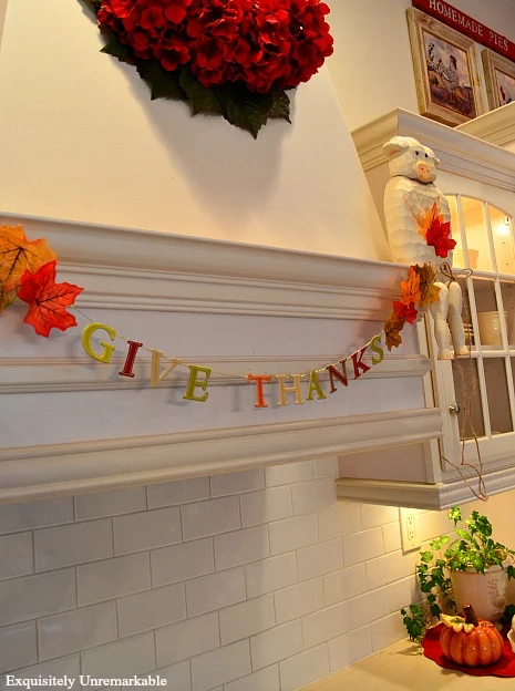 Give Thanks Letter And Leaf Banner hung on white kitchen hood