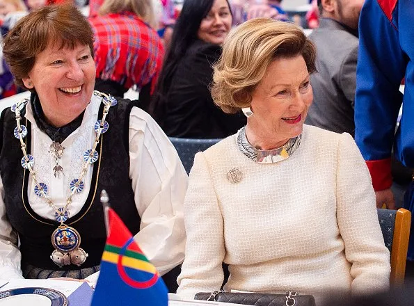 Sami people. The day is official flag-flying day. Queen Sonja Prada dress, gold necklace, diamond earrings