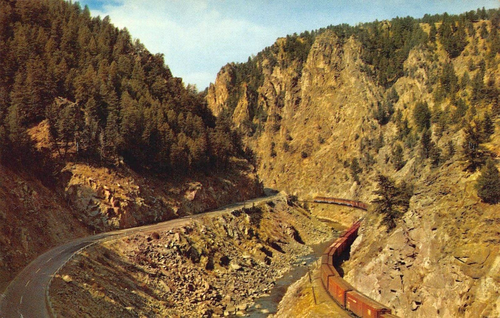 transpress nz freight train through Byers Canyon, Colorado, 1950s