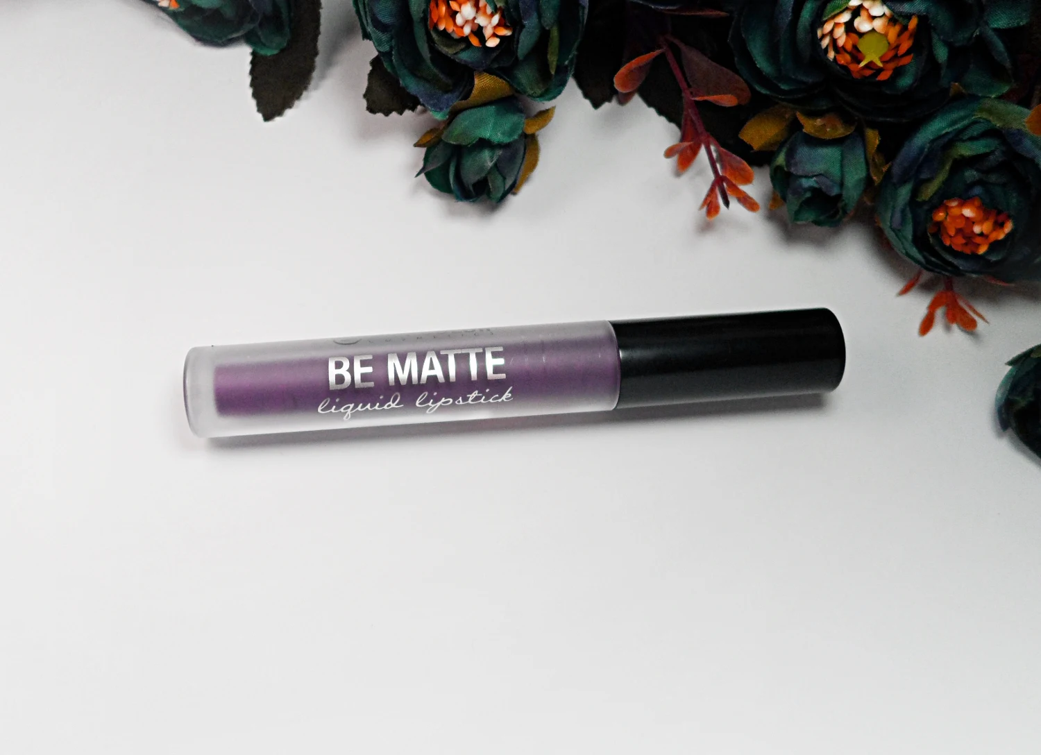 'Be Matte' lipstick by City Color Cosmetics on a white studio's background