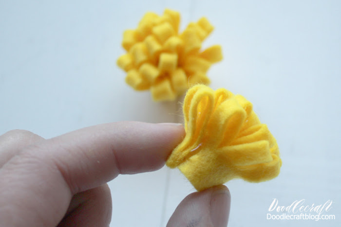 Then use the hot glue and roll the felt tightly to make a little yellow poof.  This works great as a stand alone flower or as a flower center.   I used it as a stand alone flower.