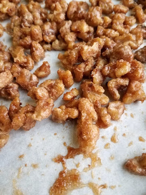 Super simple candied walnuts are spiced with the taste of fall, cinnamon, nutmeg and a hint of cloves. They are great on salads, as a garnish or eaten as is! candied nuts on baking sheet fresh from the oven