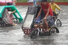 Pedicab in flooded street in Manila.