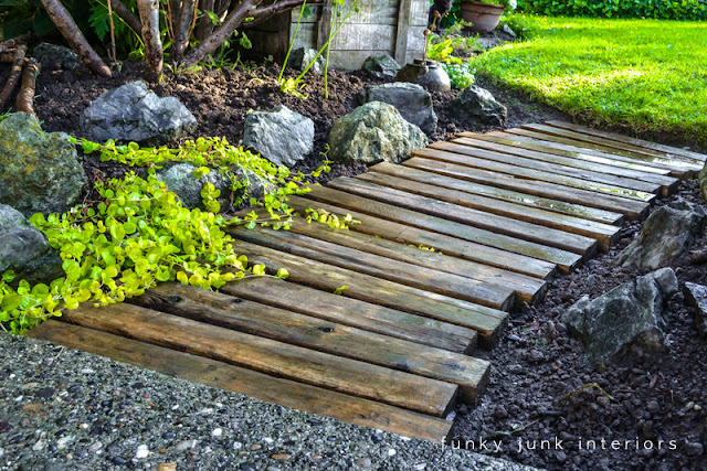 Learn how to build and upkeep this pretty pallet wood garden walkway path! Click for the instructions and how to upkeep! #palletwood #pallets #gardening #gardenpath