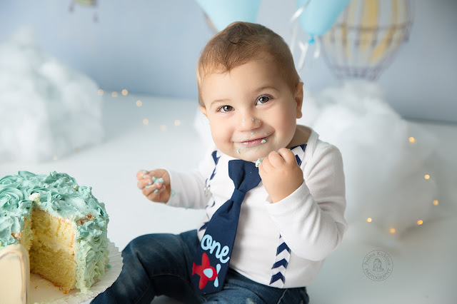 Baby-boy smashes his cake in formal wear