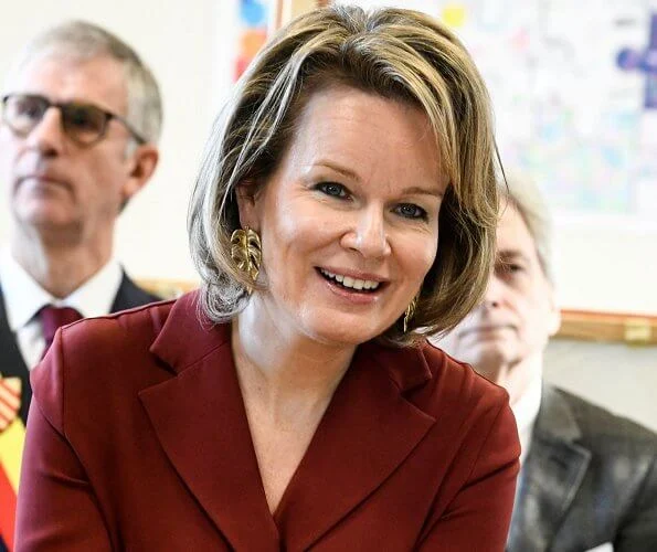 Queen Mathilde of Belgium visited a Horticultural School (Tuinbouwschool) in Melle. brown leather skirt silk blouse