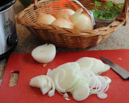Sliced onions for Slow Cooker Caramelized Onions, another building block for the inspired kitchen ♥ KitchenParade.com. Weight Watchers Friendly. Gluten Free. Easily Vegan. Great for Meal Prep.