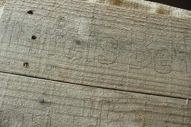 words pencilled on pallet boards
