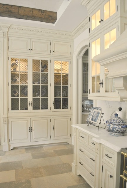 Exquisite French country white kitchen cabinets limestone floor in Enchanted Home French chateau
