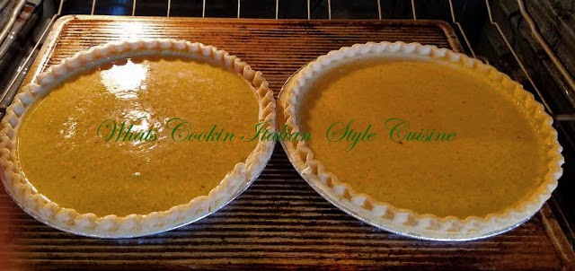 this is fresh baked homemade pumpkin pie made with fresh homemade pumpkin puree and homemade pie crust. The puree was made in a slow cooker and the pies are cooling on the the stove top.