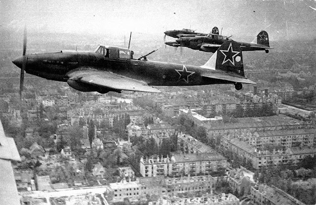 Soviet Ilyushin Il-2 ground attack aircraft fly in the skies above Berlin, Germany in 1945.