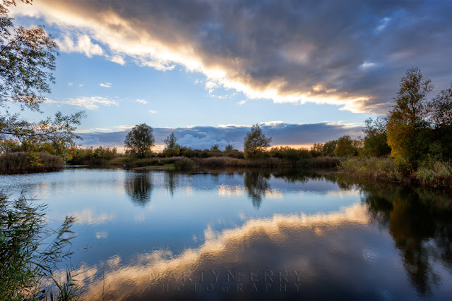 RSPB Nature Reserve at Ouse Fens as Clouds reflect in the River Ouse