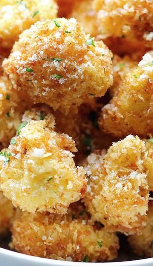 Parmesan Cauliflower Bites - Baked on parchment at 375 instead of frying and used garlic powder, onion powder, and chili powder instead of Emeril's Creole 