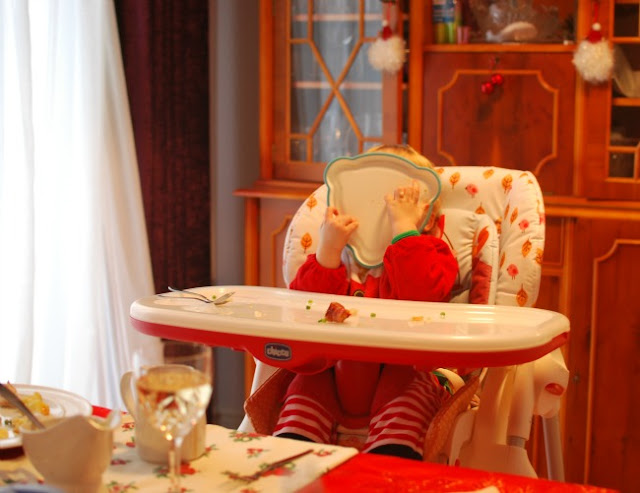 Our-First-Blogging-Christmas-picture-of-toddler-eating-with-bowl-covering-his-face