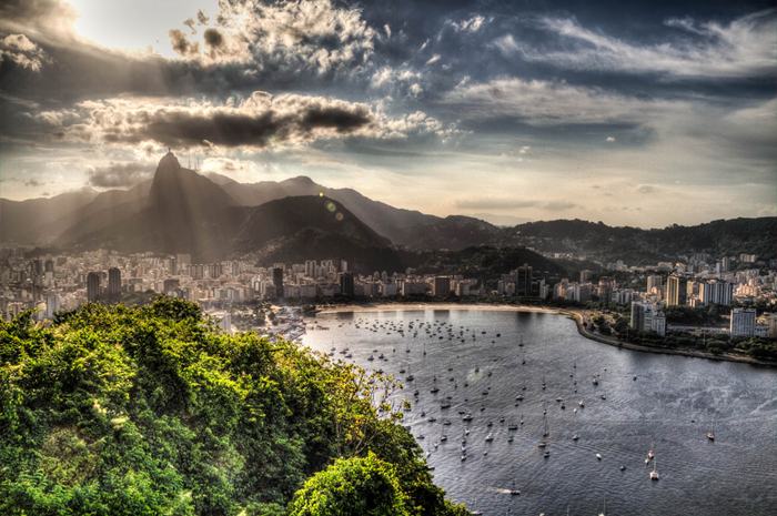Sugarloaf Mountain, is a peak situated in Rio de Janeiro, Brazil, at the mouth of Guanabara Bay on a peninsula that sticks out into the Atlantic Ocean. Rising 396 metres (1,299 ft) above the harbor, its name is said to refer to its resemblance to the traditional shape of concentrated refined loaf sugar.