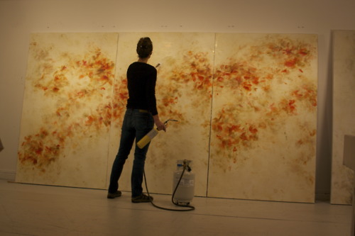 Betsy Eby with a blow torch creating an encaustic painting called THE NEW WORLD for the American embassy in Dubai.