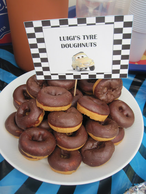 Pile of doughnuts with a sign saying Luigi's Tyres Doughnuts
