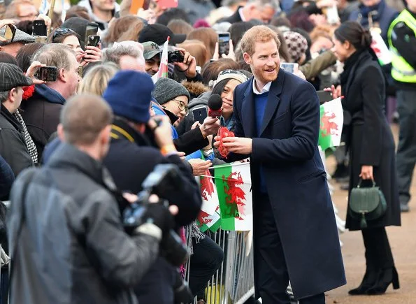 Meghan Markle carried Demellier London The Mini Venice Bag, Meghan Markle wore Tabitha Simmons Kiki boots, wore Theory wool jacket. wedding dress at ceremony