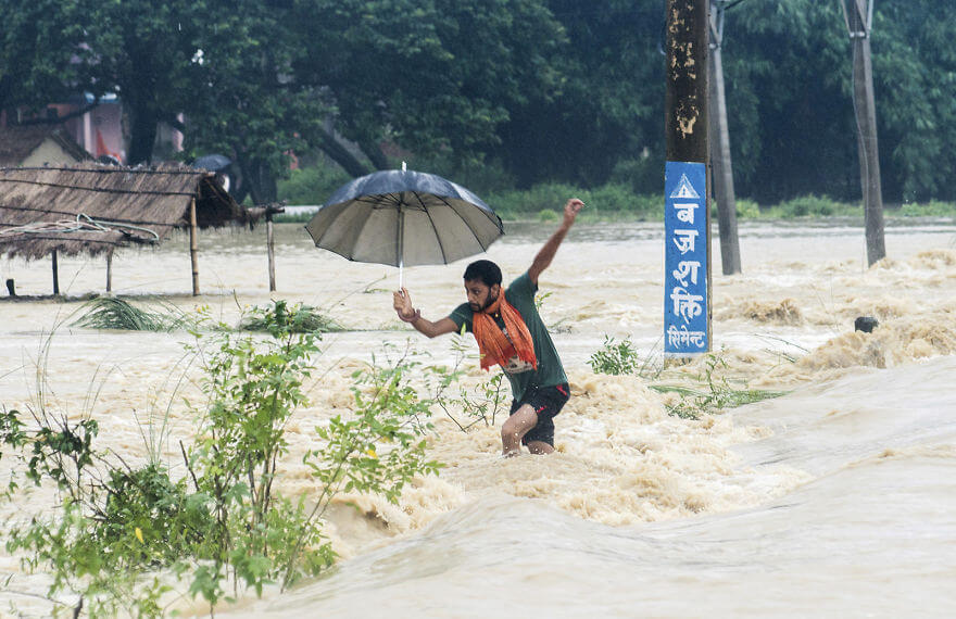 18 Devastating Pictures Of The Flooding In South Asia That Will Shock You - A Man Tries To Cross A Flooded Street In Birgunj, Nepal