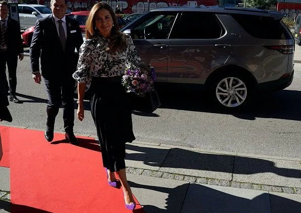 Crown Princess Mary wore a new Arlette printed crepe de chine blouse from Erdem. Gianvito Rossi purple pumps, pleated midi skirt